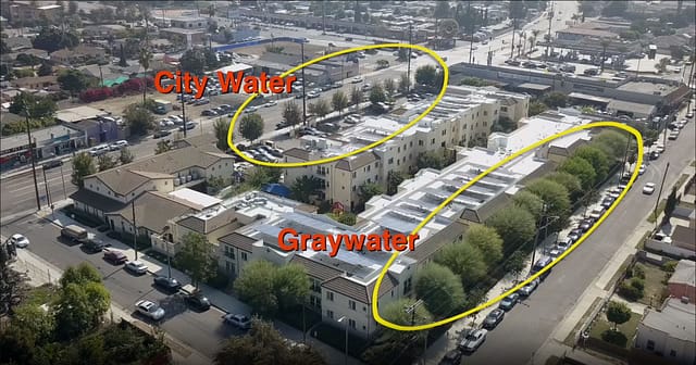 Drone footage of Casa Dominguez  apartment complex in Los Angeles showing the results of city water (small trees) and greywater (large trees)